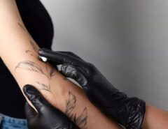 Person applying numbing cream on arm before getting a tattoo for a pain-free experience