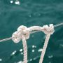 Faxco triple-strand cotton rope showcasing natural beige fibers and secure grip texture for climbing holds