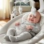 Happy infant relaxing in portable Ingenuity Soothe n Delight baby swing with soft padding.