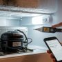 Atlanta homeowner checking refrigerator motor warning signs