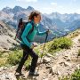 A person hiking a sunny trail wearing a cooling long sleeve sun shirt.