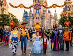 Guests in costumes enjoying Magic Kingdom during the fall Halloween event