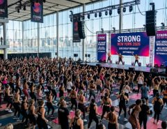 Thousands of fitness enthusiasts participating in live group workout sessions and wellness activations at Strong New York 2026 inside The Glasshouse NYC on September 26