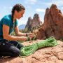 Climber examining a bright climbing rope on Colorado sandstone